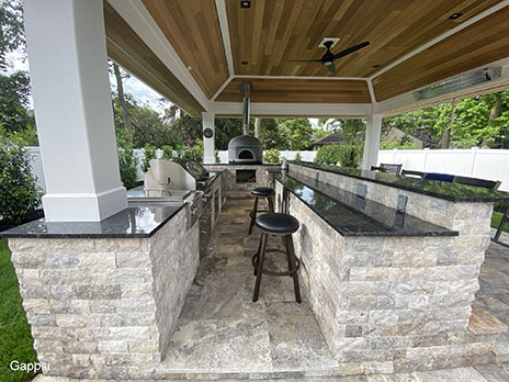 Custom-built-pavilion-with-U-shaped-cooking-island-finished-with-travertine-veneer-and-granite-countertops-in-Wantagh-Nassau-County-NY Outdoor Kitchen Design & Installation Process